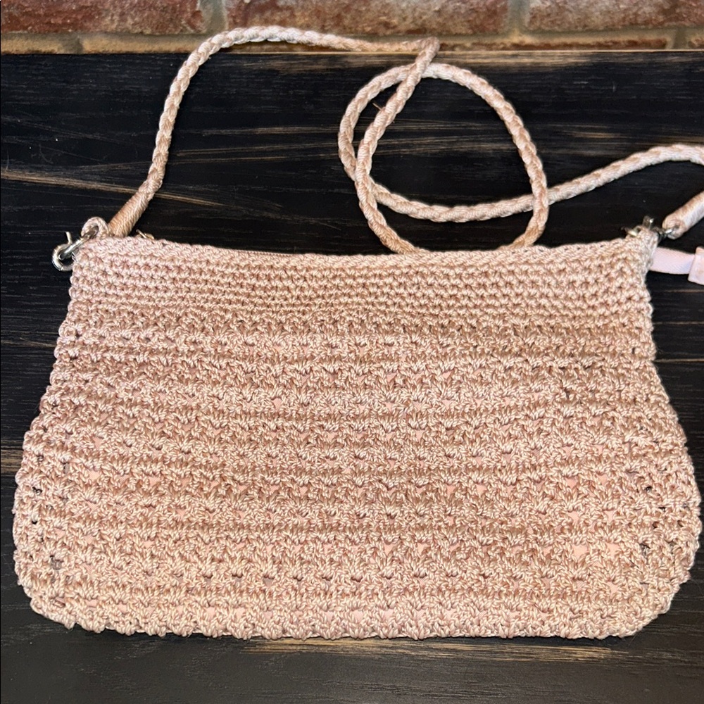 The Sak Lumi Crochet Crossbody light pink women’s purse.